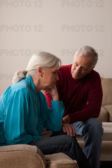 Man comforting sad senior woman. Photo : Rob Lewine