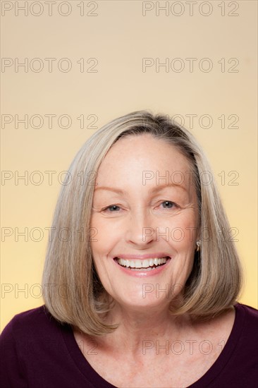 Studio shot of smiling senior woman. Photo : Rob Lewine