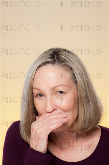 Studio shot of smiling senior woman. Photo : Rob Lewine