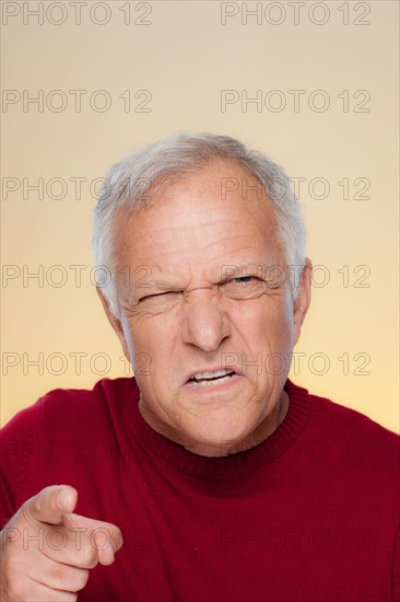 Studio shot of angry senior man. Photo : Rob Lewine