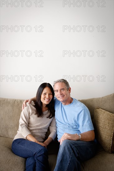 Couple in close embrace sitting on sofa. Photo : Rob Lewine