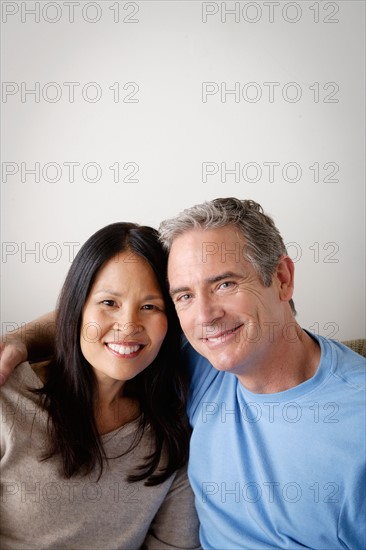 Couple in close embrace sitting on sofa. Photo : Rob Lewine