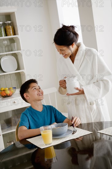 Mother serving breakfast to son. Photo : Rob Lewine