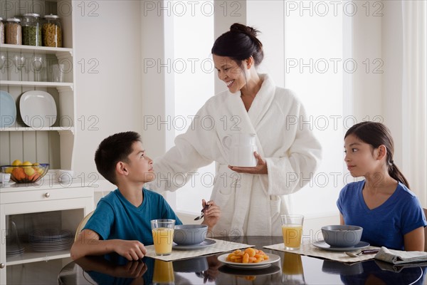 Mother serving breakfast to son and daughter. Photo : Rob Lewine