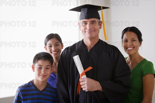 Family celebrating father's graduation. Photo : Rob Lewine