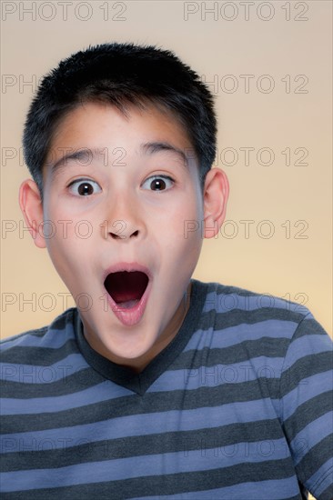 Portrait of boy with astonished expression. Photo : Rob Lewine