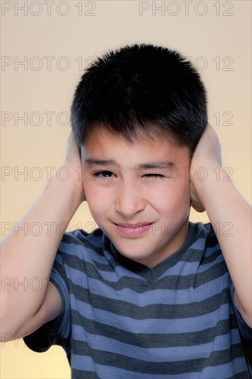 Portrait of boy making displeased expression. Photo : Rob Lewine