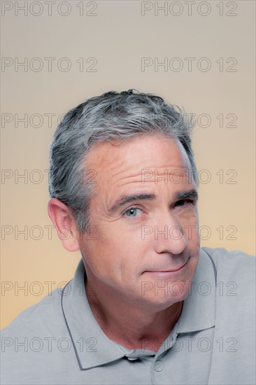 Studio Portrait of mature man winking. Photo : Rob Lewine