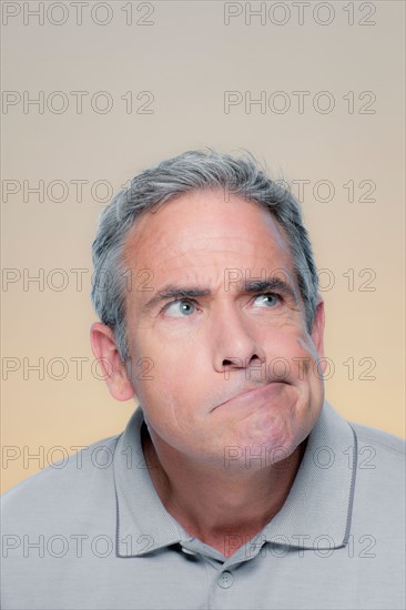 Studio Portrait of mature man making a face. Photo : Rob Lewine