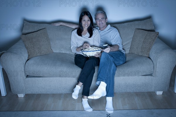 Couple watching television. Photo : Rob Lewine