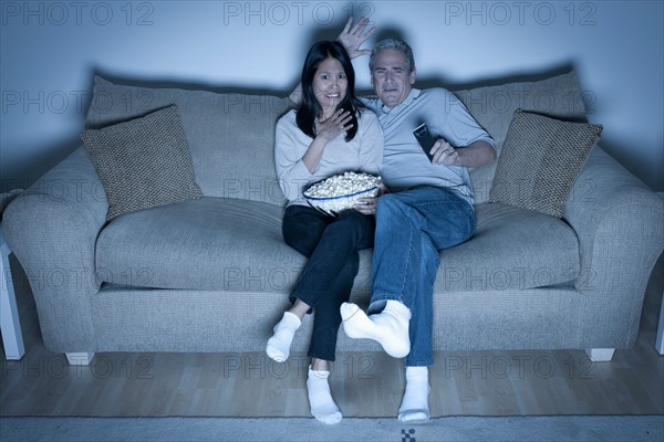 Couple watching television. Photo : Rob Lewine