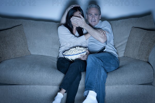 Couple watching television. Photo : Rob Lewine