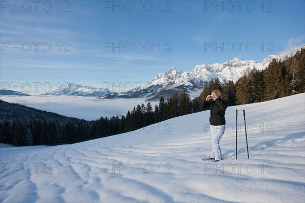 Austria, Maria Alm. Young woman hiking in winter scenery. Photo : Mark de Leeuw