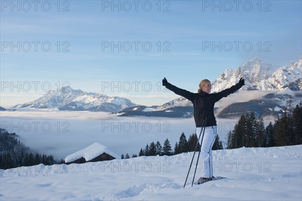 Austria, Maria Alm. Young woman hiking in winter scenery. Photo : Mark de Leeuw
