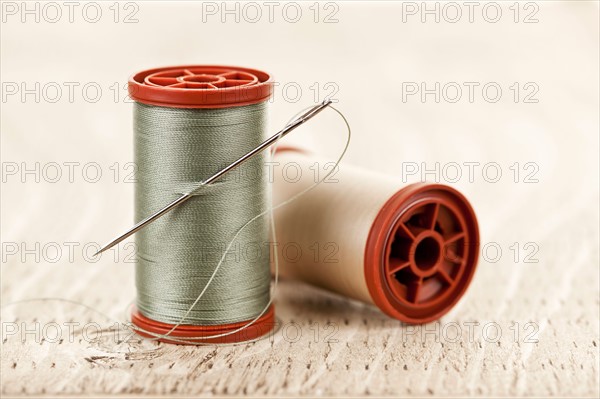 Spool of thread and needle. Photo : Elena Elisseeva