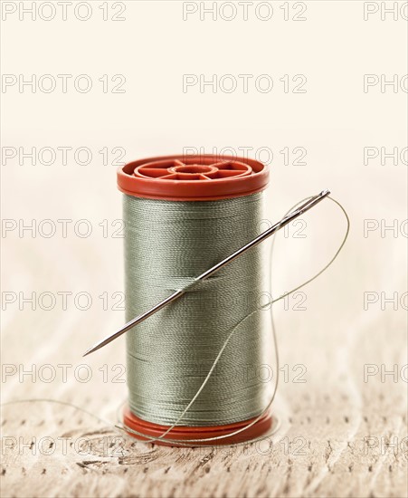 Spool of thread and needle. Photo : Elena Elisseeva