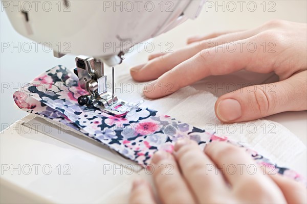 Close-up view of female hands operating machine . Photo : Elena Elisseeva