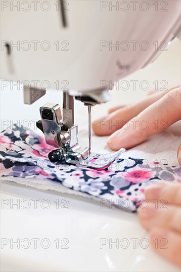 Close-up view of female hands operating machine . Photo : Elena Elisseeva