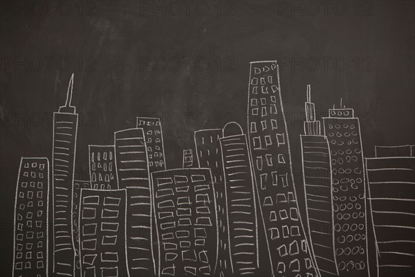 Modern city skyline drawn on blackboard. Photo : Jessica Peterson
