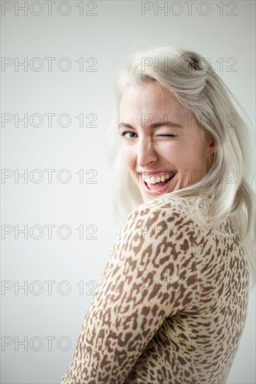 Young attractive woman blinking in front of camera. Photo : Jessica Peterson