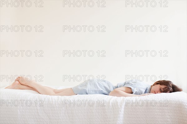 Attractive young woman sleeping in bed. Photo : Jessica Peterson