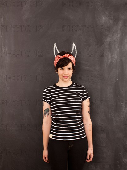 Portrait of young woman in front of blackboard. Photo : Jessica Peterson