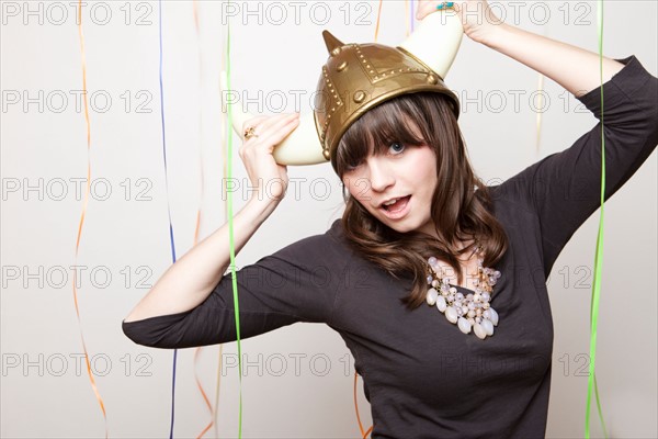 Studio Shot of young woman in Viking Helmet. Photo : Jessica Peterson