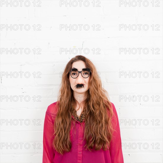 Studio Shot portrait of young woman in artificial nose. Photo : Jessica Peterson