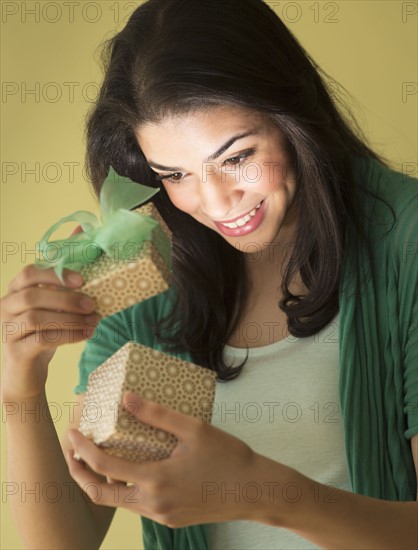 Young woman opening gift box.