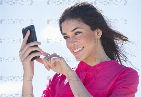 Young woman using PDA.