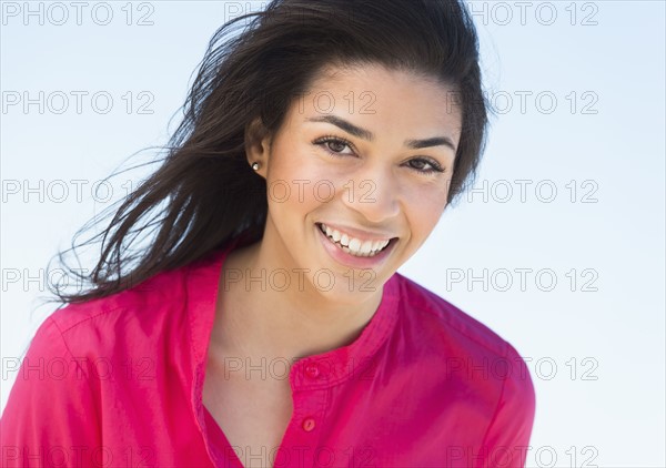 Portrait of young woman smiling.