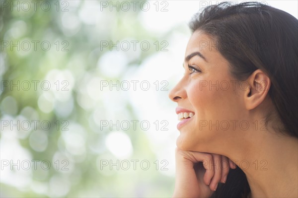 Profile of young woman looking up.