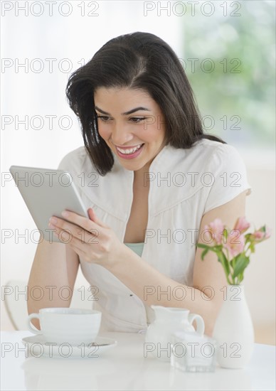 Young woman using tablet pc in restaurant.