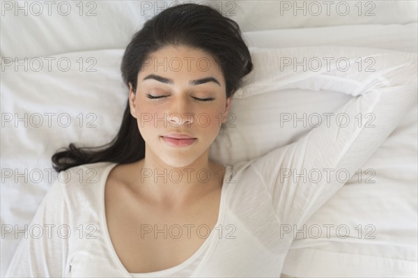 Young woman asleep in bed.
