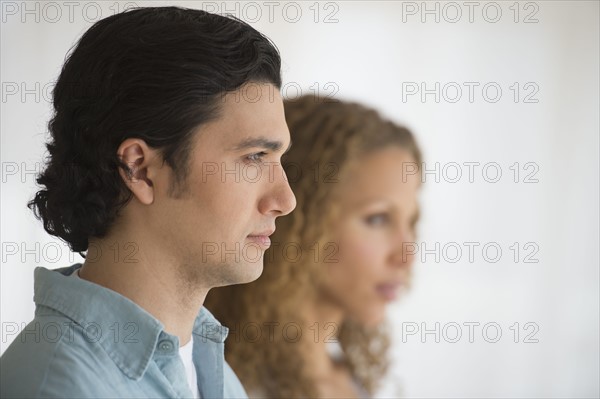 Profile of couple with focus on man in foreground.