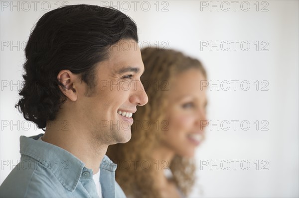 Profile of couple with focus on man in foreground.