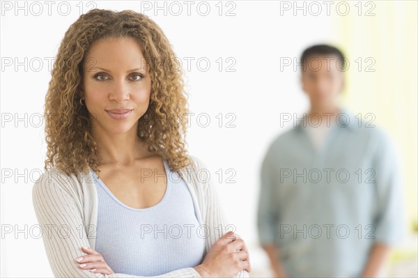 Portrait of couple with focus on woman in foreground.