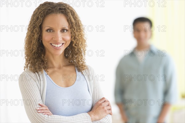 Portrait of couple with focus on woman in foreground.