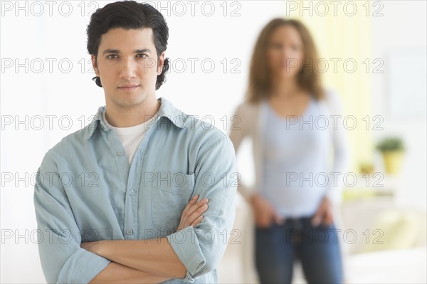 Portrait of couple with focus on man in foreground.