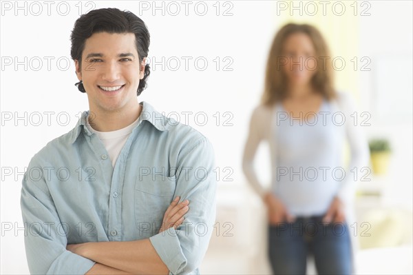 Portrait of couple with focus on man in foreground.