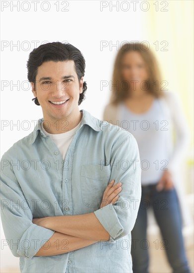 Portrait of couple with focus on man in foreground.