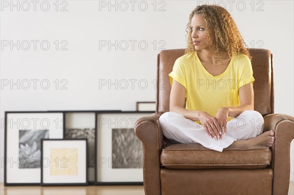 Portrait of woman sitting in armchair.