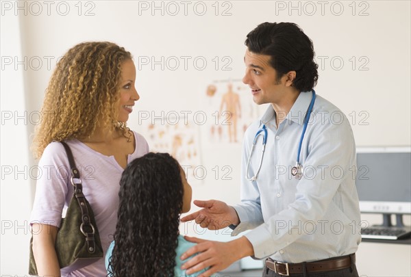 Mother with daughter (12-13) visiting pediatrician.