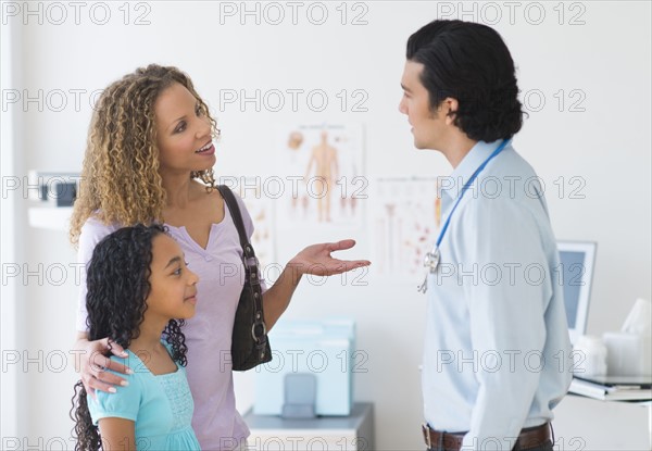 Mother with daughter (12-13) visiting pediatrician.