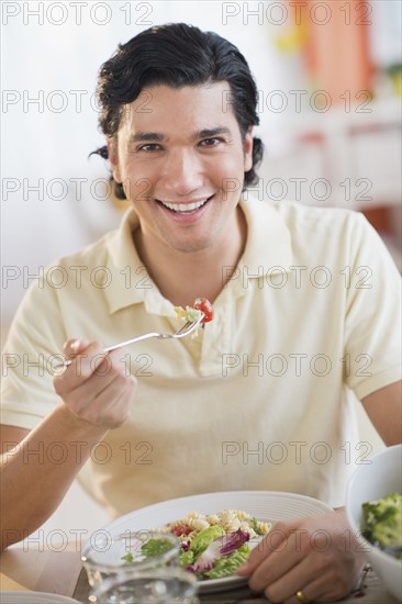 Portrait of man eating dinner.