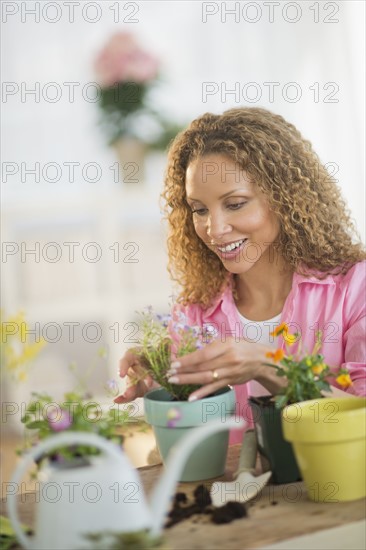 Woman potting flowers.