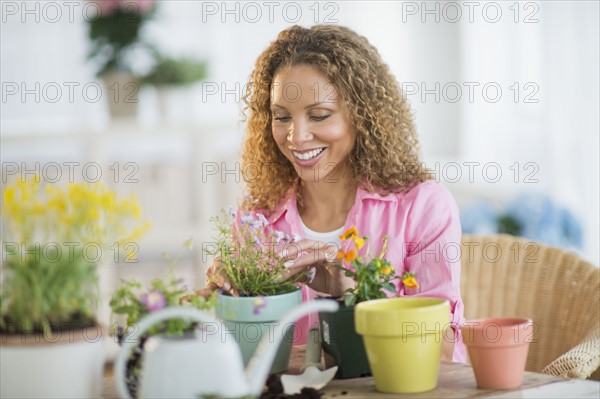 Woman potting flowers.