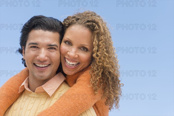 Portrait of couple against blue sky.