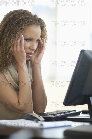 Business woman having headache in office.