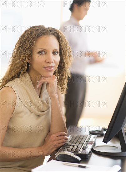 Portrait of business woman using computer.